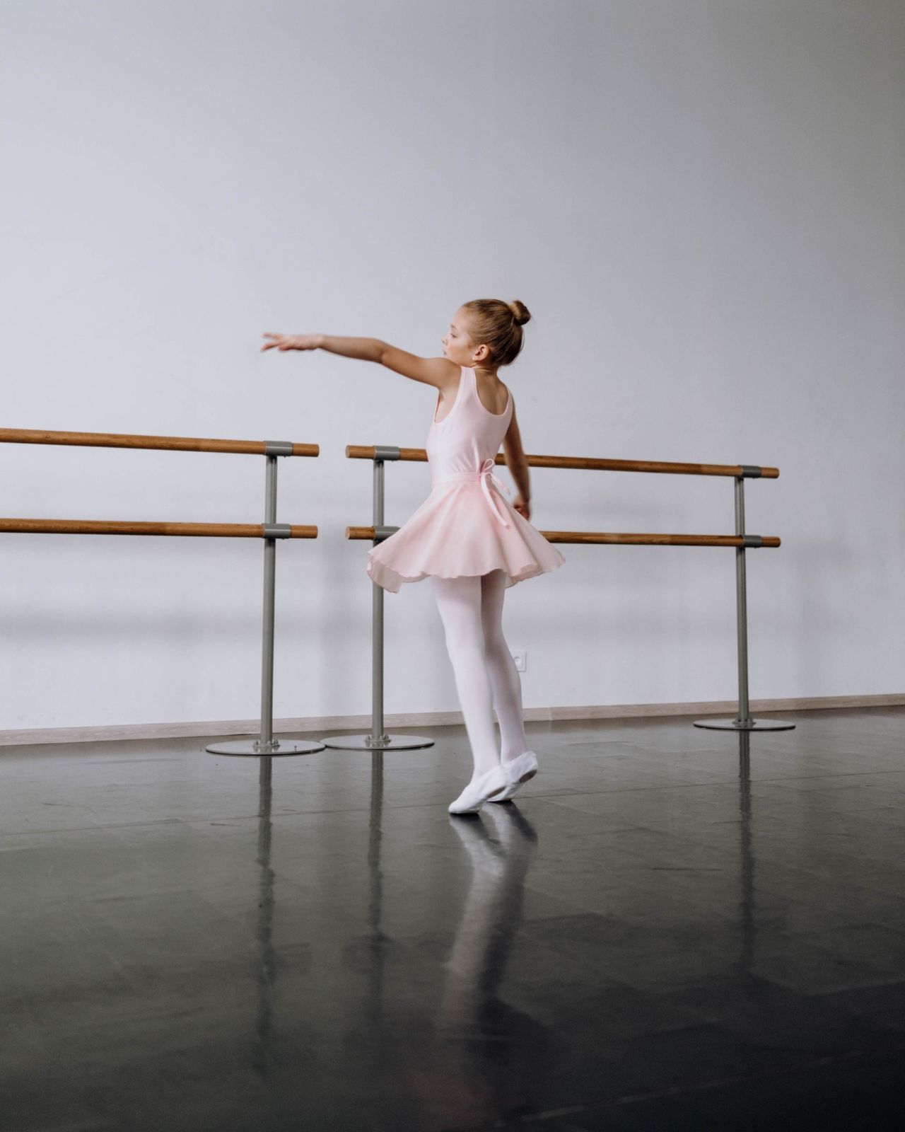 A young dancer in pink at the barre